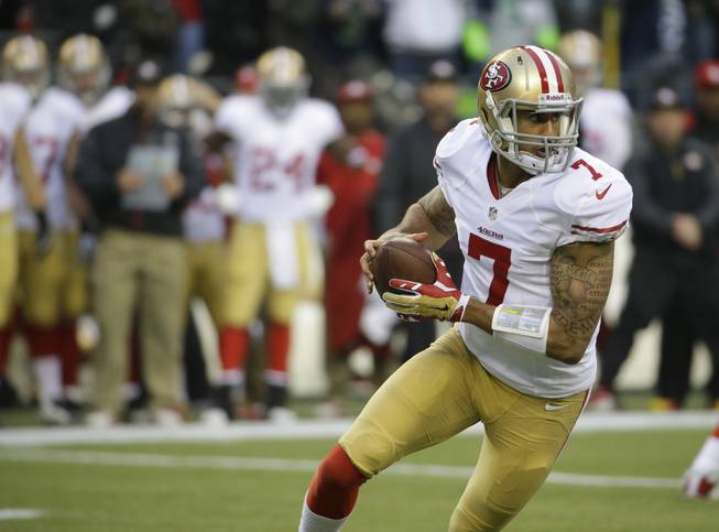 San Francisco 49ers' Colin Kaepernick (7) works against the Seattle Seahawks during the first half of the NFL football NFC Championship game Sunday, Jan. 19, 2014, in Seattle. (AP Photo/Ted S. Warren)